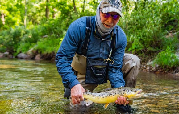 fisherman with brown trout