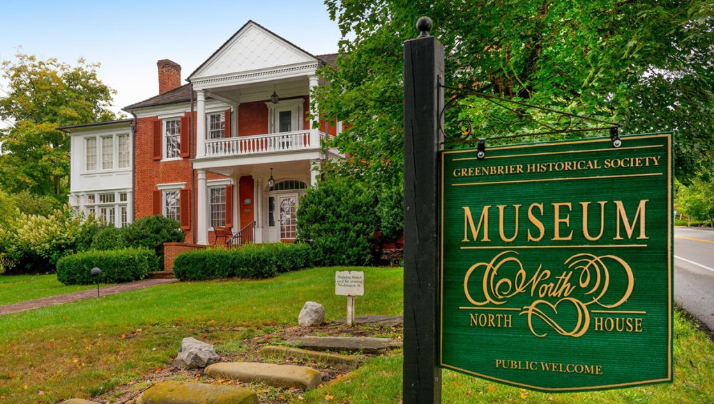 Front view of the North House Museum in Lewisburg, WV, with its historic brick architecture and welcoming sign - one of the best affordable attractions in the Greenbrier Valley.